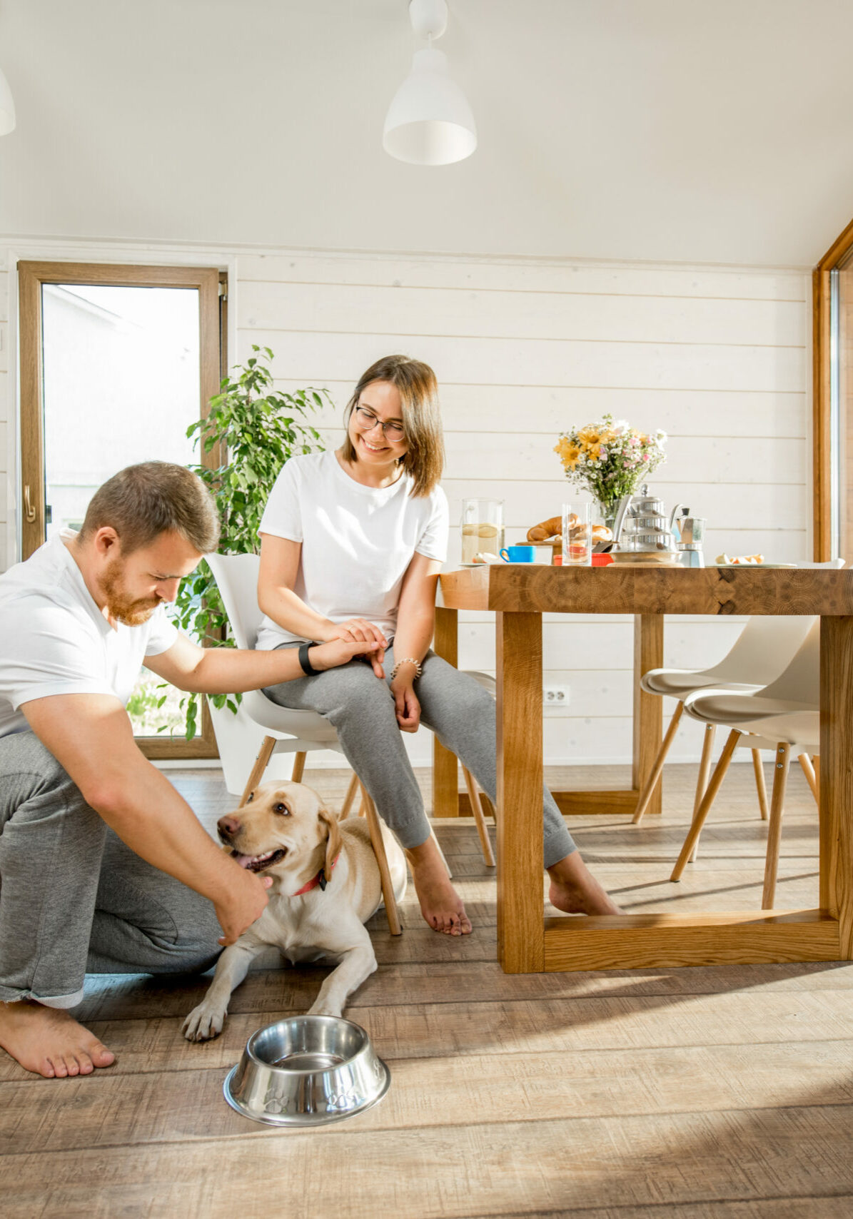 Young couple with dog at home | Floor to Ceiling Grand Rapids